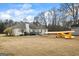 Expansive backyard with large patio, mature trees, and room to roam offers endless possibilities for outdoor enjoyment at 3403 Bill Gardner Pkwy, Locust Grove, GA 30248