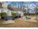 Inviting patio area featuring a fire pit, outdoor seating, and a spacious deck with steps at 3403 Bill Gardner Pkwy, Locust Grove, GA 30248