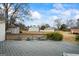 Spacious backyard viewed from a deck, featuring a large lawn, a playground, and a storage building at 3403 Bill Gardner Pkwy, Locust Grove, GA 30248