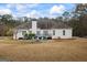 Expansive backyard showcasing a well-maintained lawn and the home's back exterior with a charming deck area at 3403 Bill Gardner Pkwy, Locust Grove, GA 30248