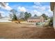 Expansive backyard featuring a patio seating area and a vintage yellow airplane at 3403 Bill Gardner Pkwy, Locust Grove, GA 30248