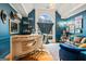 Stylish bar area boasts custom shelving, plush seating, and a large window that provides natural light at 3403 Bill Gardner Pkwy, Locust Grove, GA 30248