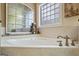 Close up of jacuzzi tub with custom windows at 3403 Bill Gardner Pkwy, Locust Grove, GA 30248