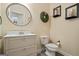 Clean and simple half bathroom with a white vanity, toilet, and neutral decor, providing a functional space at 3403 Bill Gardner Pkwy, Locust Grove, GA 30248