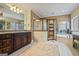 Bright bathroom with double vanity, jacuzzi tub, and glass shower at 3403 Bill Gardner Pkwy, Locust Grove, GA 30248
