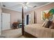Comfortable bedroom featuring a four-poster bed, soft colors, and a charming butterfly painting at 3403 Bill Gardner Pkwy, Locust Grove, GA 30248