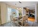 Cozy dining area featuring a wooden table, stylish chairs, and a large window offering natural light and views at 3403 Bill Gardner Pkwy, Locust Grove, GA 30248