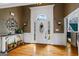 Gracious foyer features hardwood flooring, transom window and decorative console table with an adjacent doorway at 3403 Bill Gardner Pkwy, Locust Grove, GA 30248