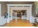 Elegant foyer with hardwood floors opening to the living room showcasing a stone fireplace at 3403 Bill Gardner Pkwy, Locust Grove, GA 30248