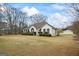 Inviting two-story home with a well-manicured front lawn and mature landscaping at 3403 Bill Gardner Pkwy, Locust Grove, GA 30248