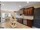 Beautiful kitchen showcasing dark wood cabinets, stainless steel appliances, granite countertops, and a center island at 3403 Bill Gardner Pkwy, Locust Grove, GA 30248