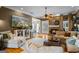 Cozy living room with hardwood floors, stone fireplace, comfortable seating, and television at 3403 Bill Gardner Pkwy, Locust Grove, GA 30248