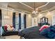 Spacious main bedroom with a tray ceiling, ceiling fan, and a private door leading to the outside at 3403 Bill Gardner Pkwy, Locust Grove, GA 30248