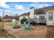 Charming patio area with outdoor seating, a fire pit, and a well-maintained deck, perfect for entertaining at 3403 Bill Gardner Pkwy, Locust Grove, GA 30248