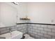 Modern bathroom features white subway tile, mosaic accent stripe, and simple decor at 560 John Wesley Dobbs Ne Ave, Atlanta, GA 30312