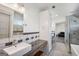 Bright bathroom featuring modern fixtures, tiled shower, and stylish vanity with storage at 560 John Wesley Dobbs Ne Ave, Atlanta, GA 30312