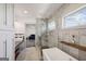Bathroom featuring a modern tub, marble shower, vanity with sink, and wood shelves at 560 John Wesley Dobbs Ne Ave, Atlanta, GA 30312