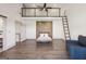 Bedroom features loft area, ladder, wood accent wall, and en-suite bathroom at 560 John Wesley Dobbs Ne Ave, Atlanta, GA 30312