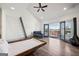Bedroom with vaulted ceiling, black fireplace, and sliding doors to a private outdoor balcony at 560 John Wesley Dobbs Ne Ave, Atlanta, GA 30312