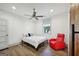 Bright bedroom features a ceiling fan, window, and red lounge chair at 560 John Wesley Dobbs Ne Ave, Atlanta, GA 30312