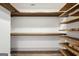 Organized closet featuring custom wood shelving and trim throughout at 560 John Wesley Dobbs Ne Ave, Atlanta, GA 30312