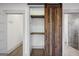Open view of the walk in closet which features custom shelving and rustic barn door at 560 John Wesley Dobbs Ne Ave, Atlanta, GA 30312