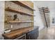 Dining area with exposed brick wall, wooden shelves, wood countertop, cabinets and wine fridge at 560 John Wesley Dobbs Ne Ave, Atlanta, GA 30312