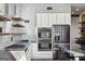 Modern kitchen features stainless appliances, double oven, white cabinets and open shelving at 560 John Wesley Dobbs Ne Ave, Atlanta, GA 30312