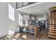 An open-concept kitchen featuring a modern island, stainless steel appliances, and a floating staircase at 560 John Wesley Dobbs Ne Ave, Atlanta, GA 30312