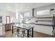 A contemporary kitchen featuring an island with breakfast bar, modern lighting, and stainless steel appliances at 560 John Wesley Dobbs Ne Ave, Atlanta, GA 30312