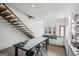 Modern kitchen features a floating staircase, stainless steel appliances, island and white cabinets at 560 John Wesley Dobbs Ne Ave, Atlanta, GA 30312