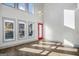 Bright and airy living room with large windows, wood floors, and a red modern door at 560 John Wesley Dobbs Ne Ave, Atlanta, GA 30312