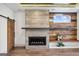 Living room with a striking fireplace, wood accent wall, and sliding barn door at 560 John Wesley Dobbs Ne Ave, Atlanta, GA 30312