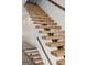 Modern staircase with wood treads, metal frame, and wire railing detail create a unique design at 560 John Wesley Dobbs Ne Ave, Atlanta, GA 30312