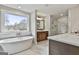Elegant bathroom featuring a soaking tub, a glass-enclosed shower, and double vanities at 110 Warren Way, Fayetteville, GA 30215