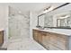 Bathroom featuring a glass shower, double sinks, and sleek finishes at 110 Warren Way, Fayetteville, GA 30215