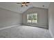 Large bedroom showcases a vaulted ceiling, a ceiling fan, and a bright window with outdoor views at 110 Warren Way, Fayetteville, GA 30215