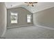 Spacious bedroom featuring vaulted ceilings, two windows, and neutral carpeting at 110 Warren Way, Fayetteville, GA 30215