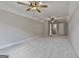 Expansive bonus room has two ceiling fans, plush carpet, and ample natural light at 110 Warren Way, Fayetteville, GA 30215