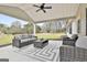 Stylish covered patio with wicker furniture, ceiling fan, and an outdoor living space at 110 Warren Way, Fayetteville, GA 30215