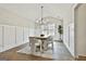 Elegant dining room featuring modern lighting, stylish chairs, and wainscoting at 110 Warren Way, Fayetteville, GA 30215