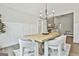 Elegant dining room featuring a wooden table, plush chairs, modern lighting, and stylish wainscoting at 110 Warren Way, Fayetteville, GA 30215