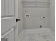 Convenient laundry room is equipped with tile flooring and washer-dryer hookups at 110 Warren Way, Fayetteville, GA 30215