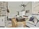 Bright and spacious living room featuring a stone fireplace and comfortable seating arrangements at 110 Warren Way, Fayetteville, GA 30215