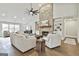 Bright living room featuring a stone fireplace, built-in shelving, hardwood floors, and comfortable seating at 110 Warren Way, Fayetteville, GA 30215