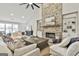 Bright living room with a soaring stone fireplace, built-in shelving, and multiple seating areas at 110 Warren Way, Fayetteville, GA 30215
