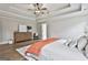 Bright main bedroom features hardwood floors, a tray ceiling, and a neutral color palette at 110 Warren Way, Fayetteville, GA 30215