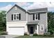 Charming two-story home with gray siding, black shutters, and a two-car garage at 7728 Sudbury Cir, Covington, GA 30014