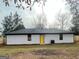 Backyard featuring a recently installed fence, an interesting home exterior, and a well-kept yard at 95 Grove Creek Dr, Locust Grove, GA 30248