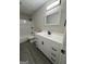 The bathroom features a modern vanity with black hardware, a combined shower-tub, and stylish lighting at 95 Grove Creek Dr, Locust Grove, GA 30248